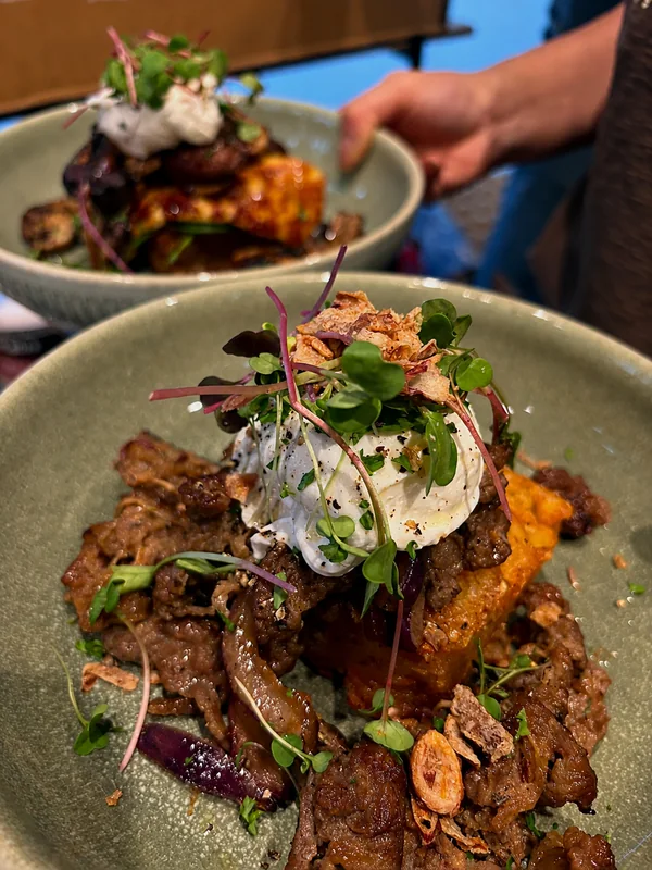 Two bowls of brunch with eggs and mushrooms