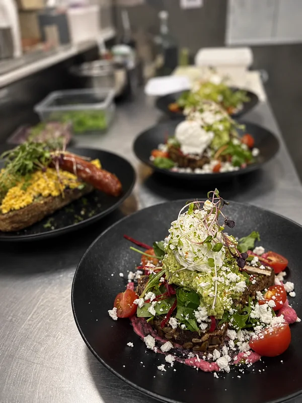 Avocado toast with poached egg, feta and salad