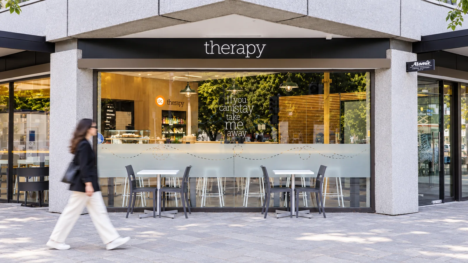 Therapy Coffee frontage at 77 Hereford Street, with its therapy sign and outdoor tables